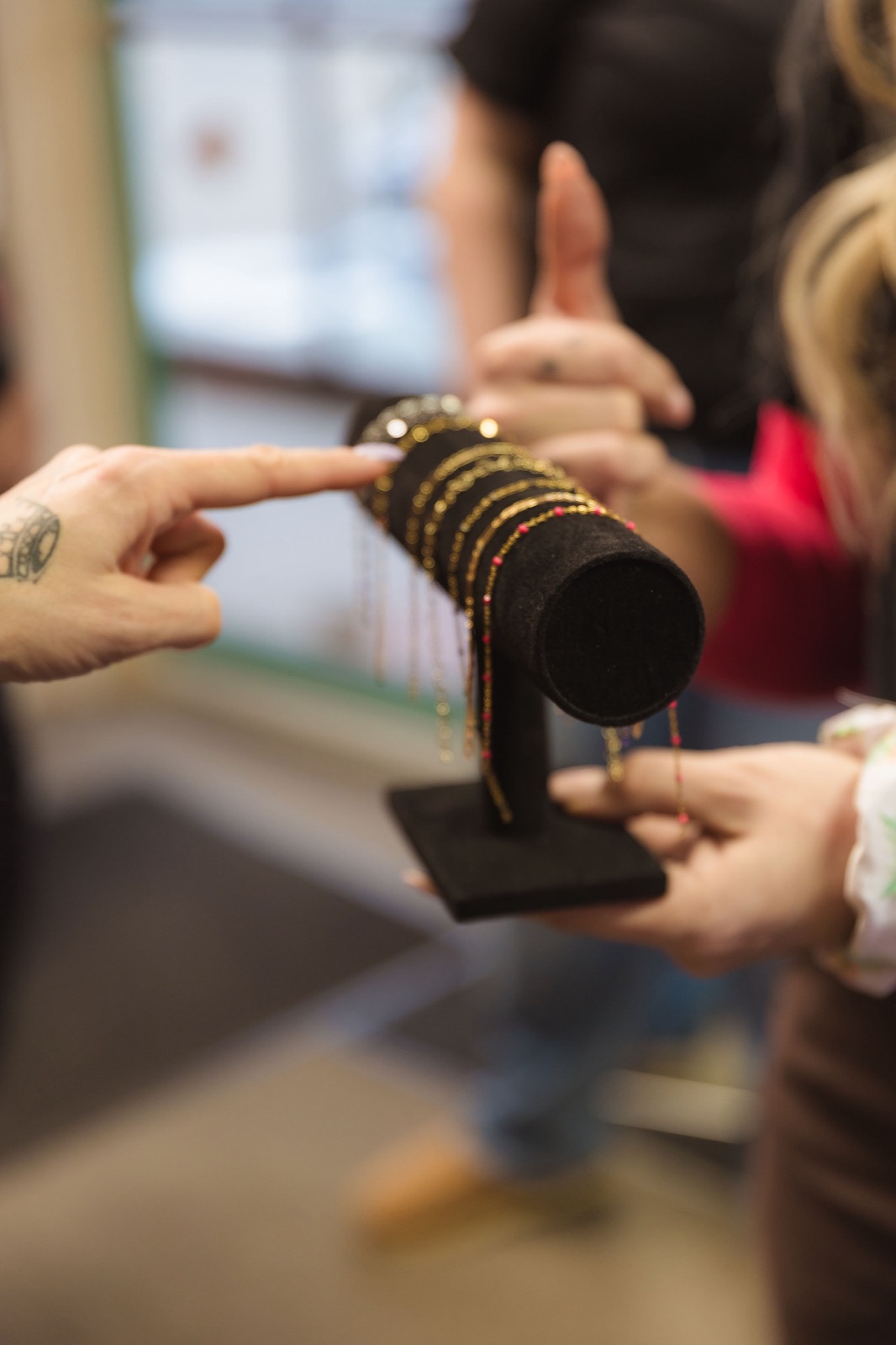 Permanent jewelry chains on a display stand